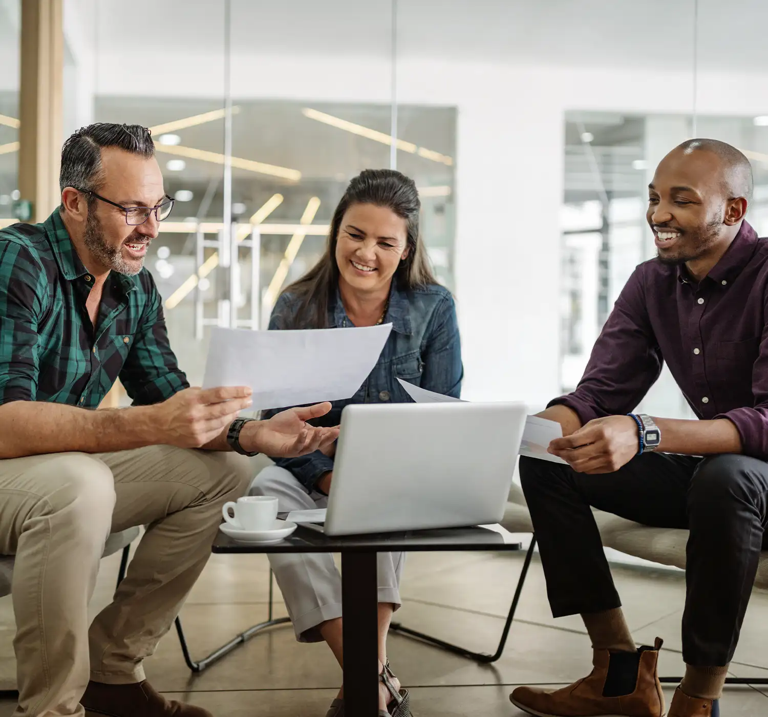 Business advisors consulting with clients in modern office environment