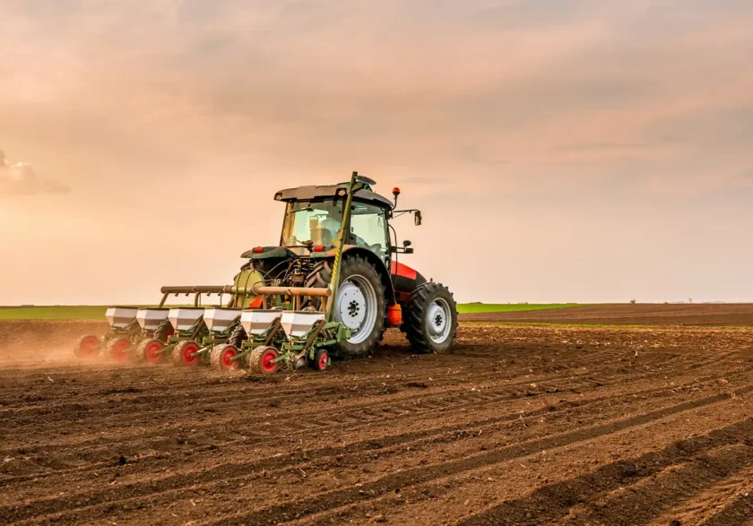Agricultural tractor plowing farmland representing modern farming and agricultural operations